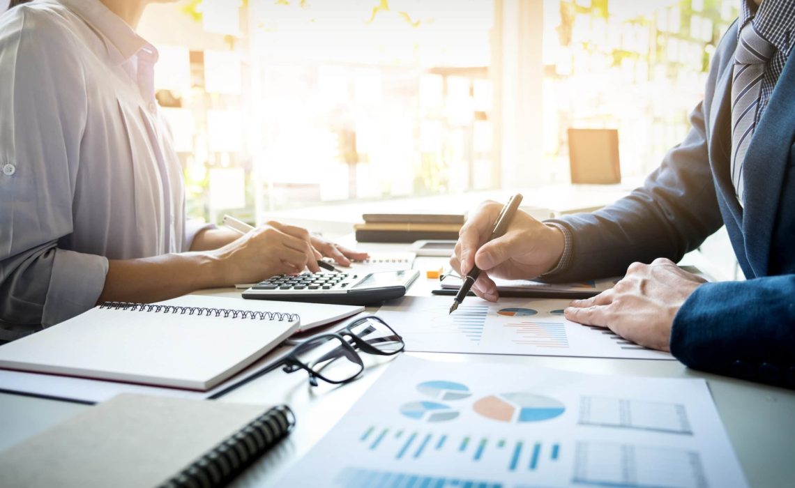 business man financial inspector and secretary making report, ca business man financial inspector and secretary making report, calculating or checking balance. Internal Revenue Service inspector checking document. Audit concept
