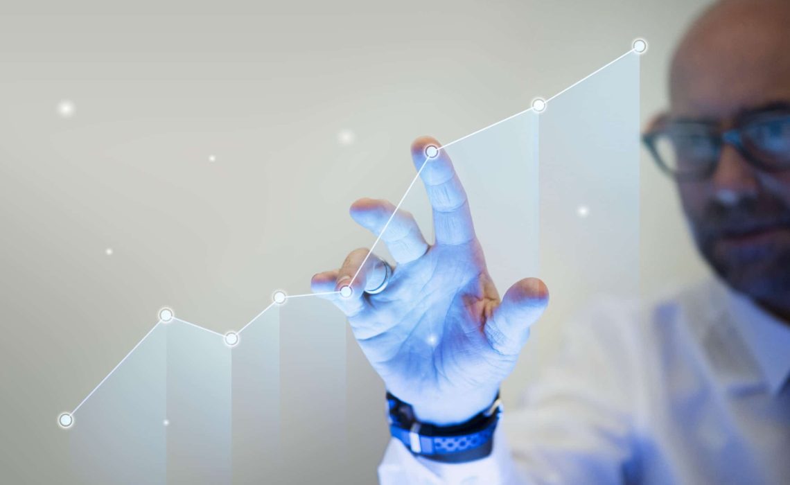 Businessman pointing his finger to a growth graph